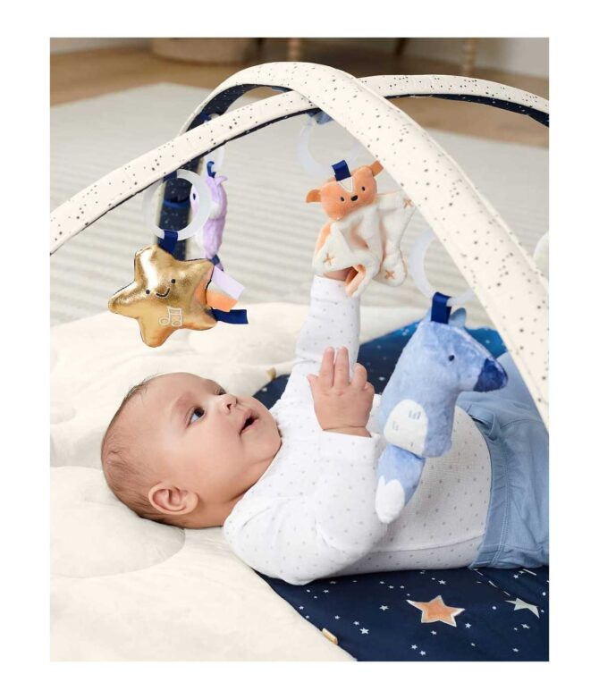 Bebé jugando boca arriba en Gimnasio de actividades para bebé celestial Dreams Skip HOP